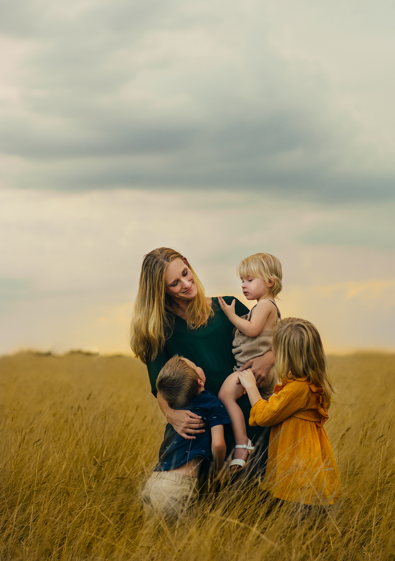 Mother with children in field of long grass