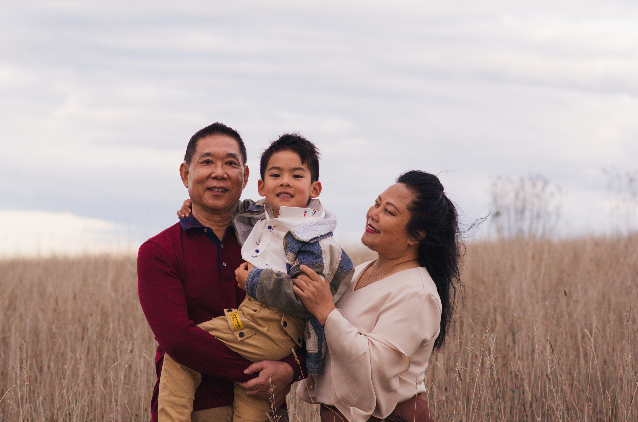 family portrait photography posing in field of grass